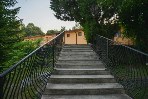 a staircase leading up to a building with a fence at Village of Peace - House 39 in Shkodër