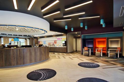 a lobby of a store with a counter and chairs at Tru By Hilton Meridian in Meridian