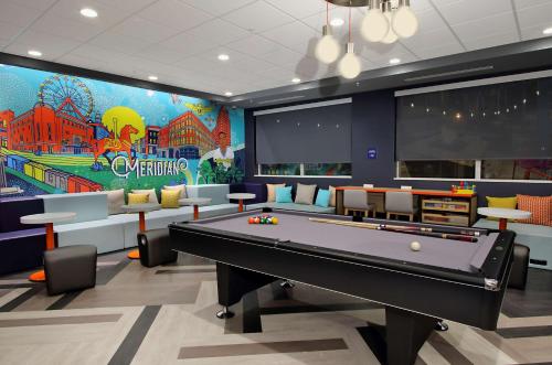 a gaming room with a pool table and a large mural at Tru By Hilton Meridian in Meridian