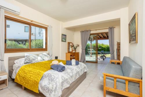a bedroom with a bed with a yellow blanket at Blue Bay Villa Nicole in Mavroli