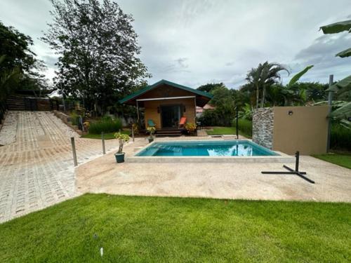 a swimming pool in a yard with a house at Casa Cooper in Carrillo