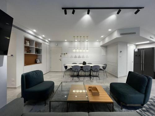 a living room with a dining room table and chairs at David Residence New Private apartment in Jerusalem