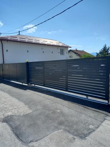 a black fence in front of a house at Apartments Natural and Bungalows in Sarajevo