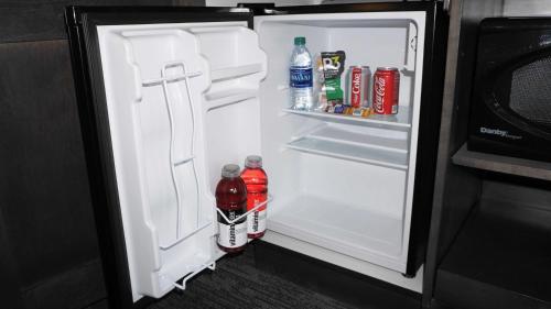 an open refrigerator with soda and drinks in it at Hampton Inn & Suites Memphis Germantown in Memphis