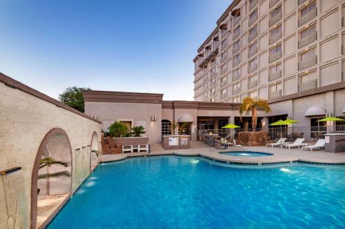 a swimming pool in front of a hotel at Doubletree by Hilton Phoenix Mesa in Mesa