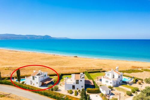 an aerial view of a white house with a red circle at Blue Bay Villa Thea in Mavroli
