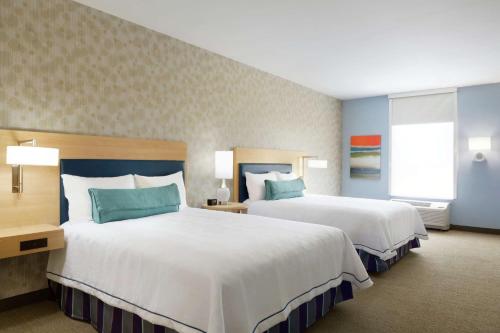 a hotel room with two beds and a window at Home2 Suites By Hilton McAllen in McAllen
