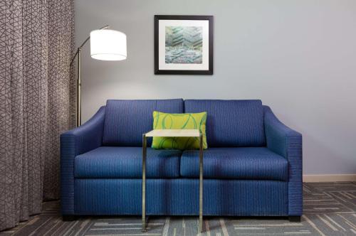 a blue couch with a yellow pillow on a table at Hampton Inn Wetumpka in Wetumpka