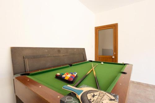 a green pool table with balls in a room at Villa Tsikkos Tessera in Argaka