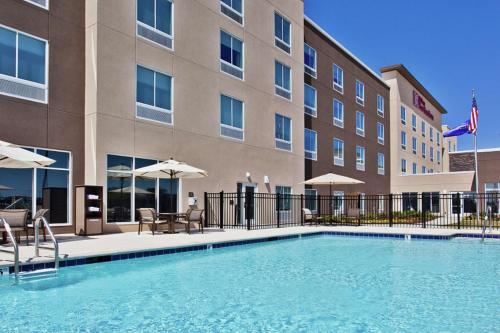 a swimming pool in front of a hotel at Hilton Garden Inn Montgomery - EastChase in Montgomery
