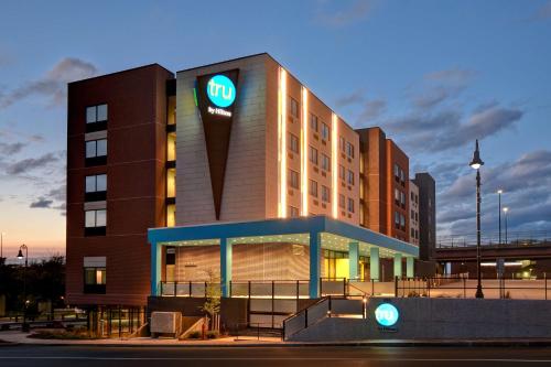 a hotel with a sign on the front of it at Tru By Hilton Manchester Downtown in Manchester