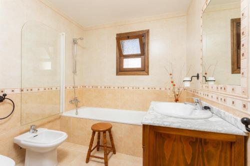 a bathroom with a sink and a tub and a toilet at Villa Flores in Almuñécar
