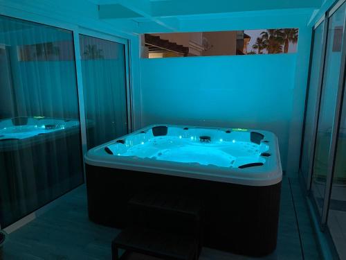 a bathroom with a tub with a blue light at Villa Dru in Roquetas de Mar