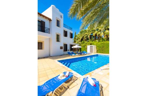 a villa with a swimming pool and a house at Villa Anna in Lachi