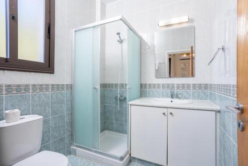 a bathroom with a shower and a toilet and a sink at Villa Anna in Lachi