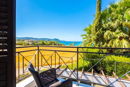 a balcony with two chairs and a view of the ocean at Villa Anna in Lachi