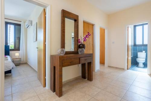 a bathroom with a wooden table and a mirror at Villa Anna in Lachi