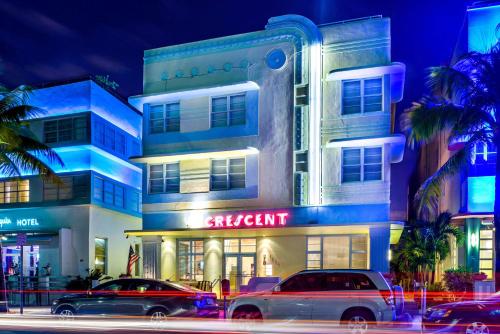 a building with cars parked in front of it at Hilton Vacation Club Crescent on South Beach Miami in Miami Beach