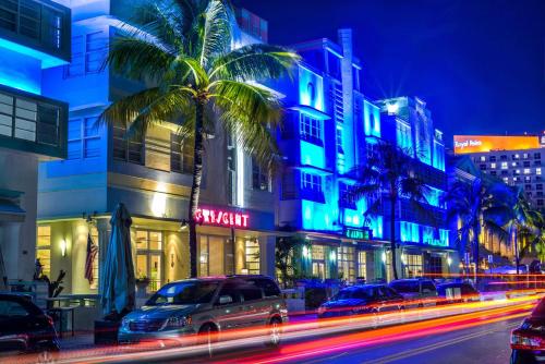 a city street with cars and buildings at night at Hilton Vacation Club Crescent on South Beach Miami in Miami Beach