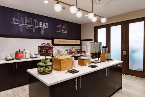 a kitchen with a counter with food on it at Hampton Inn & Suites Miami Airport South/Blue Lagoon in Miami