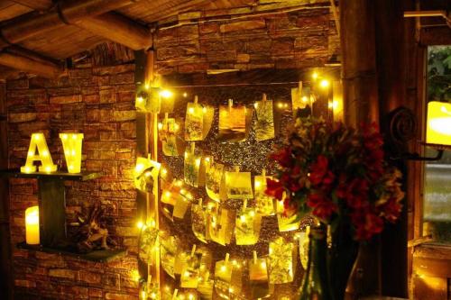 a room with candles and lights on a brick wall at Aldea Victoria. in Santa Elena