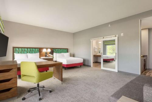 a hotel room with two beds and a desk at Hampton Inn & Suites Miami, Kendall, Executive Airport in Kendall