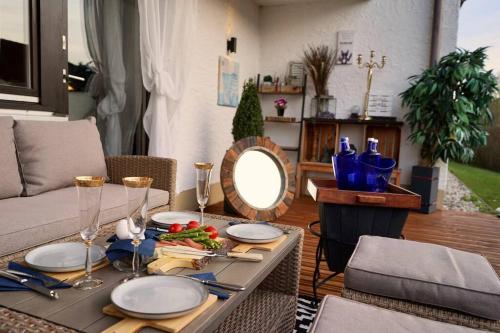 a table with a plate of food and a mirror at Terrassenwohnung Bibi am Chiemsee in Grabenstätt