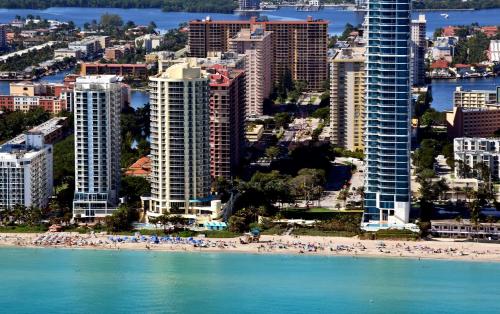 an aerial view of a beach and buildings at DoubleTree by Hilton Ocean Point Resort - North Miami Beach in Miami Beach