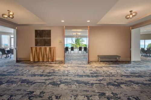 a lobby with a table and chairs in a room at DoubleTree by Hilton Ocean Point Resort - North Miami Beach in Miami Beach