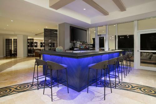 a kitchen with a blue bar with stools at DoubleTree by Hilton Ocean Point Resort - North Miami Beach in Miami Beach