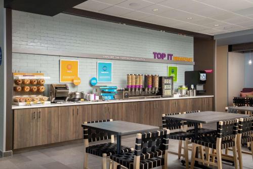 a fast food restaurant with two tables and chairs at Tru By Hilton Miami West Brickell in Miami