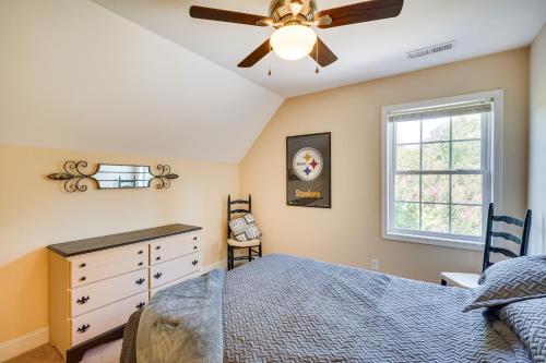 a bedroom with a bed and a ceiling fan at Semora Vacation Rental with Dock on Hyco Lake! in Semora