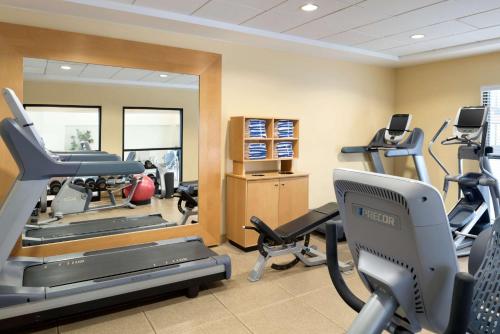 a gym with treadmills and ellipticals in a room at DoubleTree by Hilton Milwaukee/Brookfield in Brookfield