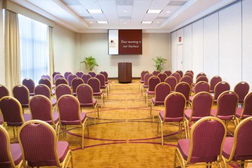 a room with rows of chairs and a podium at DoubleTree by Hilton Milwaukee/Brookfield in Brookfield