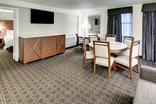 a hotel room with a table and a bedroom at DoubleTree by Hilton Milwaukee Downtown in Milwaukee