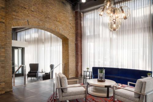 a lobby with a blue couch and chairs and a table at Homewood Suites By Hilton Milwaukee Downtown in Milwaukee
