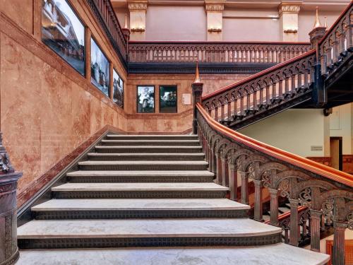 a staircase in an old building with a stair case at Hilton Garden Inn Milwaukee Downtown in Milwaukee