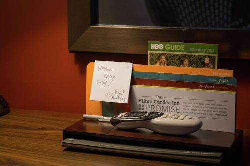 a book and a computer mouse on a table at Hilton Garden Inn Milwaukee Downtown in Milwaukee