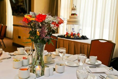 a table with a vase of flowers on it at Hilton Garden Inn Milwaukee Downtown in Milwaukee