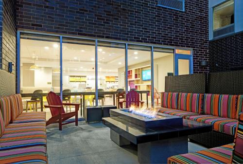 a patio with two couches and a fire pit at Home2 Suites By Hilton Milwaukee Downtown in Milwaukee