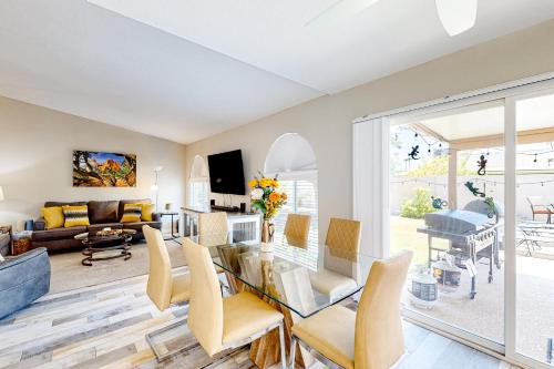 a living room with a glass table and chairs at WeeCasa in Chandler