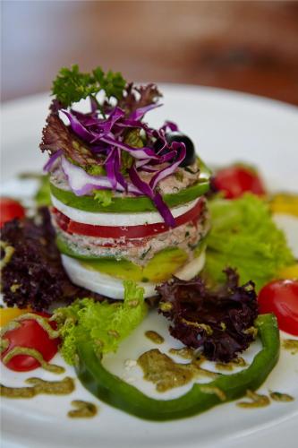 a white plate with a sandwich with vegetables on it at Bagus Jati Health & Wellbeing Retreat in Tegalalang