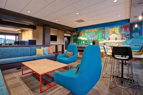 a waiting room with a couch and a table and chairs at Tru By Hilton Manassas, Va in Manassas