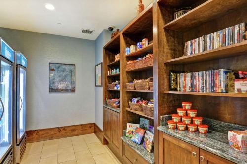 a library with wooden shelves with dvds at Homewood Suites Mobile East Bay/Daphne in Daphne