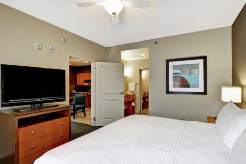 a bedroom with a bed and a flat screen tv at Homewood Suites Mobile East Bay/Daphne in Daphne