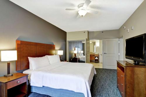 a bedroom with a bed and a flat screen tv at Homewood Suites Mobile East Bay/Daphne in Daphne