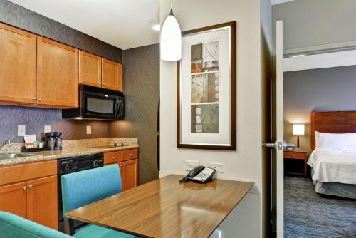 a small room with a kitchen and a bed at Homewood Suites Mobile East Bay/Daphne in Daphne