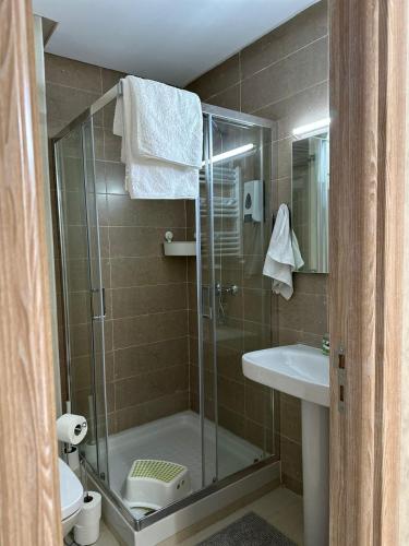 a bathroom with a shower and a toilet and a sink at Ifrane apartment with swimming pool in Ifrane