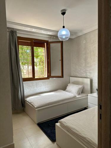 a bedroom with two beds and a window at Ifrane apartment with swimming pool in Ifrane