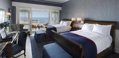 a hotel room with a bedroom with a bed and a desk at Madison Beach Hotel, Curio Collection by Hilton in Madison